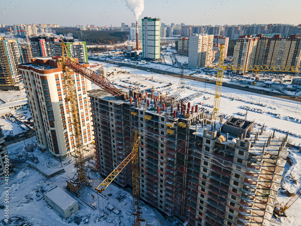 Fototapeta premium Aerial view of new constructions works on development site with high tower cranes. Building Real Estate.