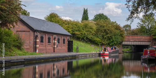 Bild auf Leinwand Canalside building with barge