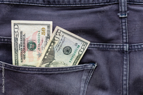 One hundred American Dollars Banknote in a jeans pocket on rotating table. Extreme close-up, Shallow Depth of Field. Business