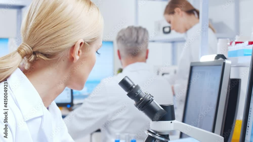 Professional team of scientists is working on a vaccine in a modern scientific research laboratory. Genetic engineer workplace. Future technology and science. Professional team of scientists is working on a vaccine in a modern scientific research laboratory. Genetic engineer workplace. Future technology and science.