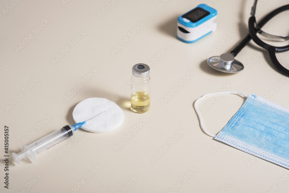 Mass vaccination against cronovirus. A syringe with a vaccine. Elements for diagnosis of COVID-19. Mass vaccination against cronovirus. A syringe with a vaccine. Elements for diagnosis of COVID-19.