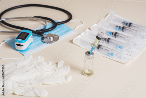 Vaccine readiness. Syringe with vaccine and necessary elements for diagnosis and vaccination