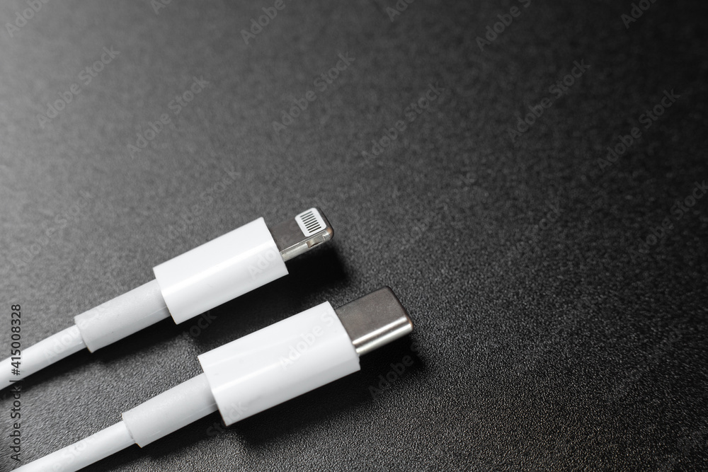 Naklejka premium mobile charging cables on black background