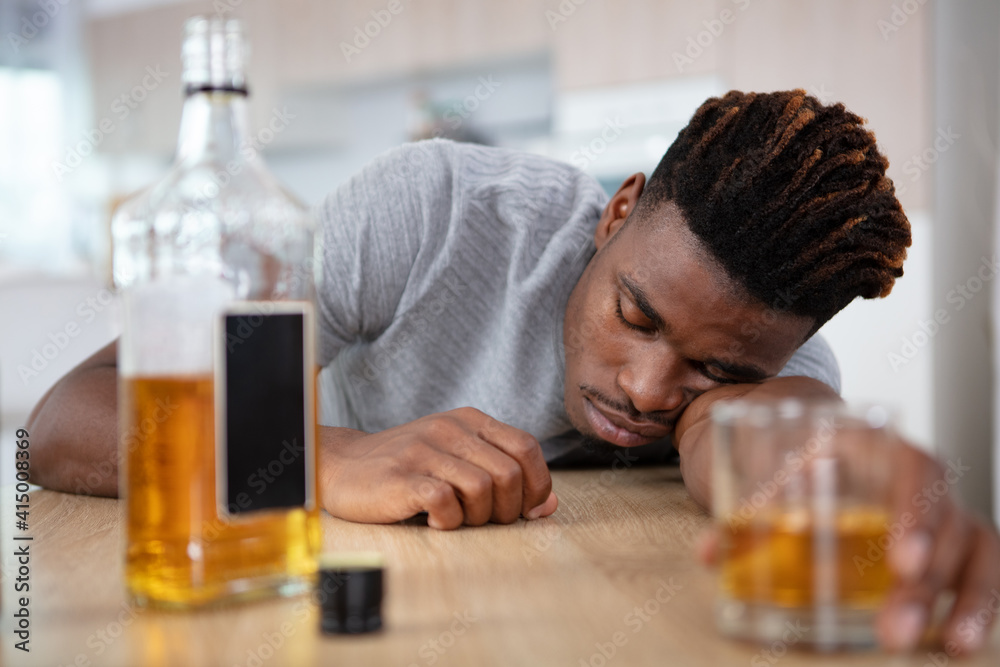 alcohol addicted man sleeping at the table alcohol addicted man sleeping at the table