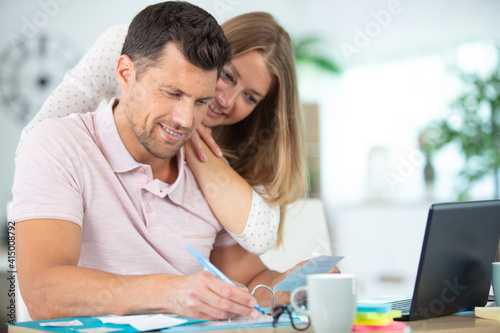 a loving couple using laptop