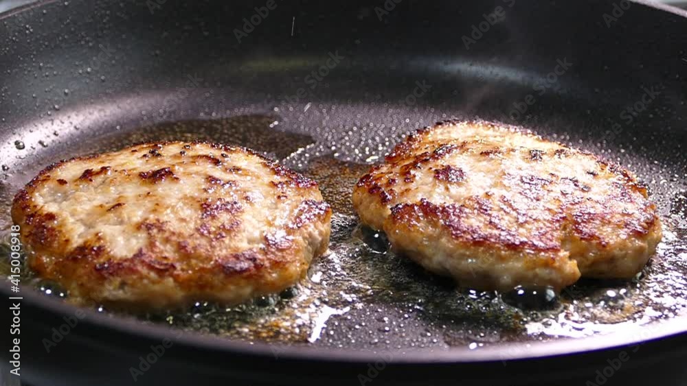Fry the cutlets in a pan with oil. Meatballs for burger close-up. The meat dish is prepared on the stove.