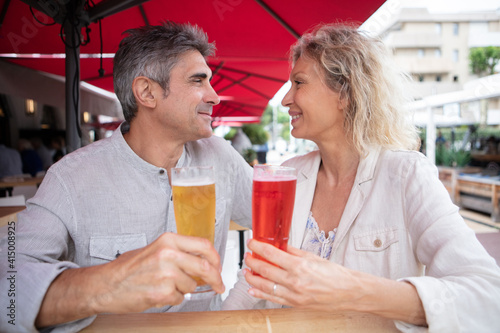 mature couple enjoying outdoor summer drink at pub