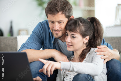 happy couple using a laptop computer