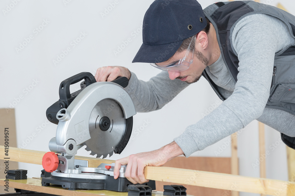 young man using circular saw young man using circular saw