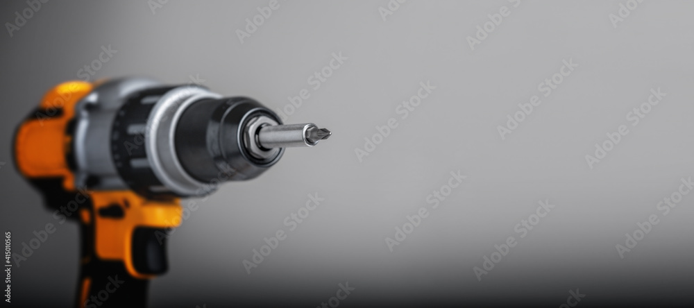 Yellow-black cordless Combi Drill Driver Hammer Drill on gray background. Yellow-black cordless Combi Drill Driver Hammer Drill on gray background.