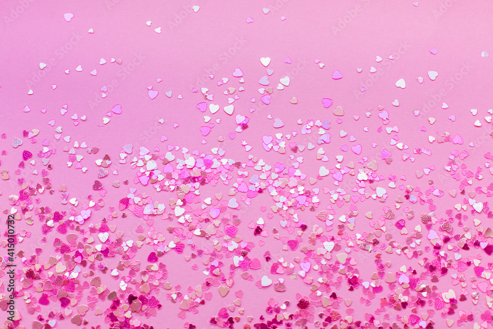 Abstract background of pink heart-shaped sparkles.