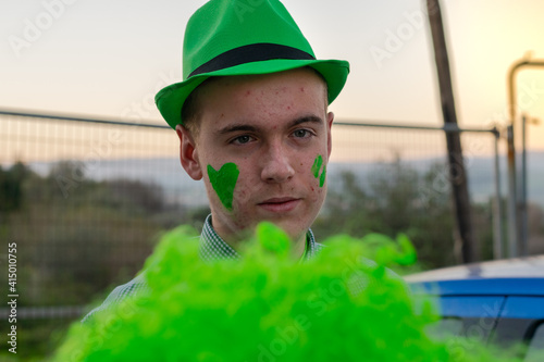 boy holding a green wig on St. Patrick's Day 