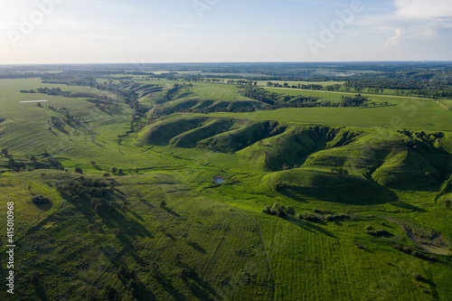 aerial view on the green canyon and fields in summer at sunset