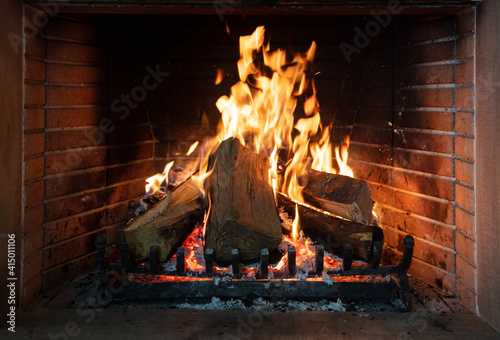 Burning fireplace, real wood logs, cozy warm home at xmas time