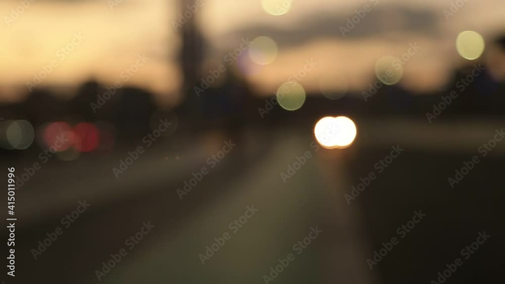Defocused traffic lights, abstract blurred bokeh image of a city with cars passing by during the sunset Defocused traffic lights, abstract blurred bokeh image of a city with cars passing by during the sunset