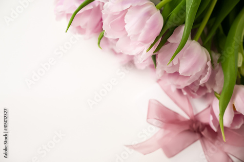 Fototapeta Naklejka Na Ścianę i Meble -  Spring. Closeup of a gift near a bunch of pink tulips. Festive. Women's day, mother's day, birthday, anniversary, easter.