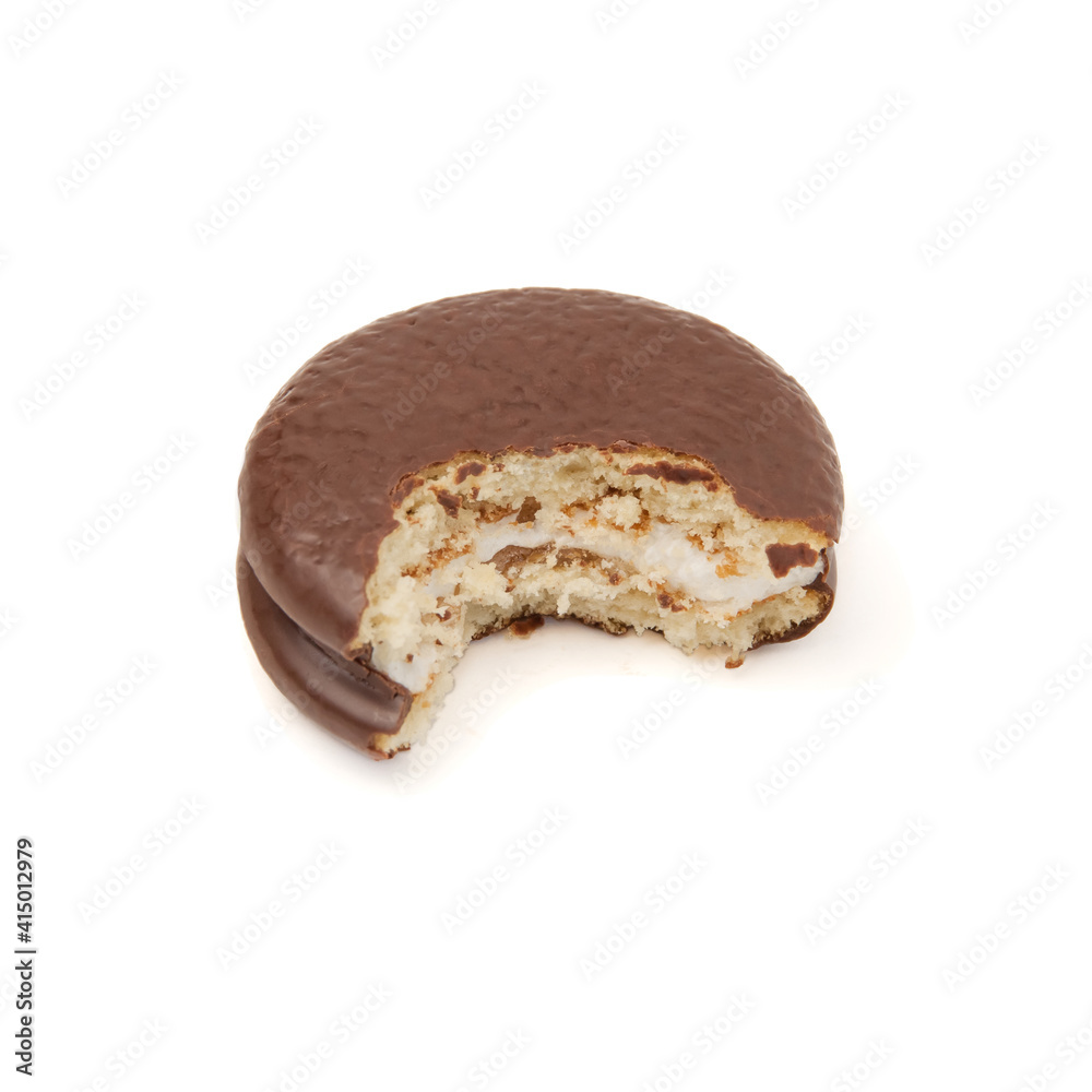 Piece of chocolate cake chokopie bitten off isolated on a white background perspective view Piece of chocolate cake chokopie bitten off isolated on a white background perspective view