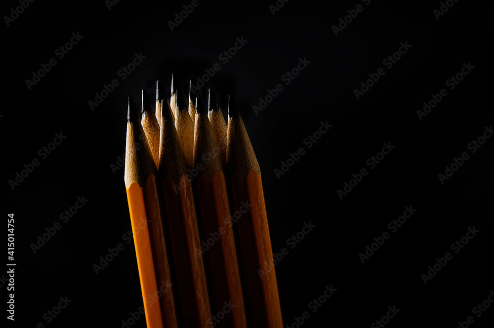 group of pencils isolated on pure black background group of pencils isolated on pure black background