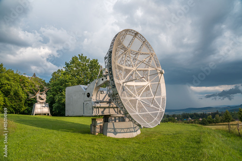 Satellite dish in a summer landscape, radiotelescope for deep space research. Ondrejov observatory, Czech republic. photo