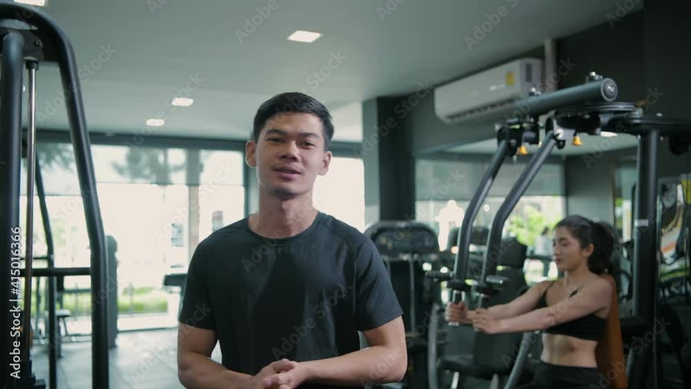 Fitness concept of 4k Resolution. Asian male trainer gives an interview at the gym. Fitness concept of 4k Resolution. Asian male trainer gives an interview at the gym.