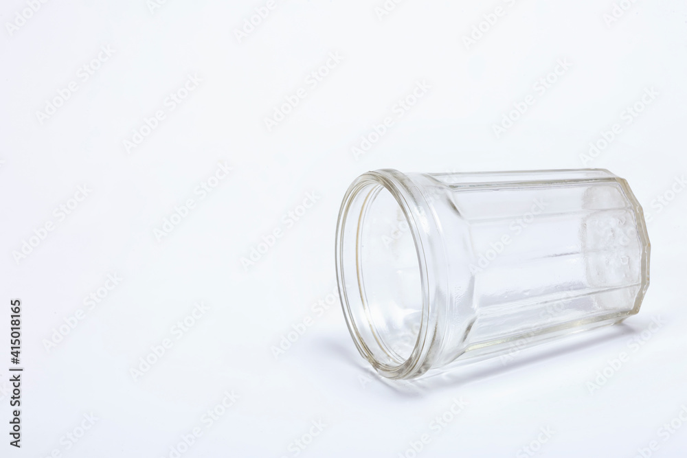 Faceted glass lying on white background Faceted glass lying on white background