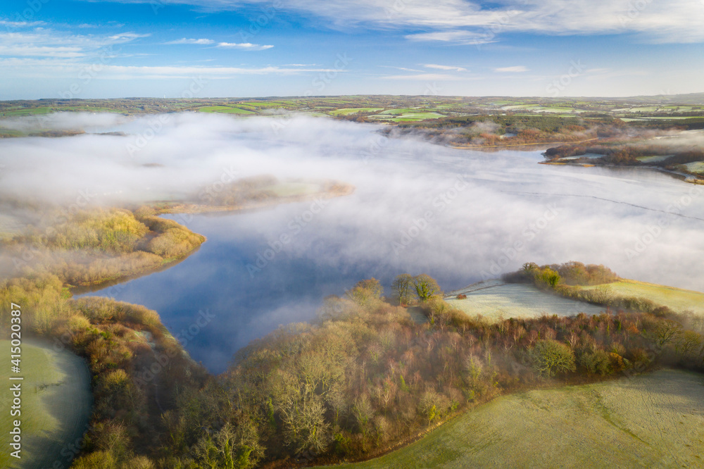 View by drone of morning mist in winter over Roadford Lake in Devon View by drone of morning mist in winter over Roadford Lake in Devon