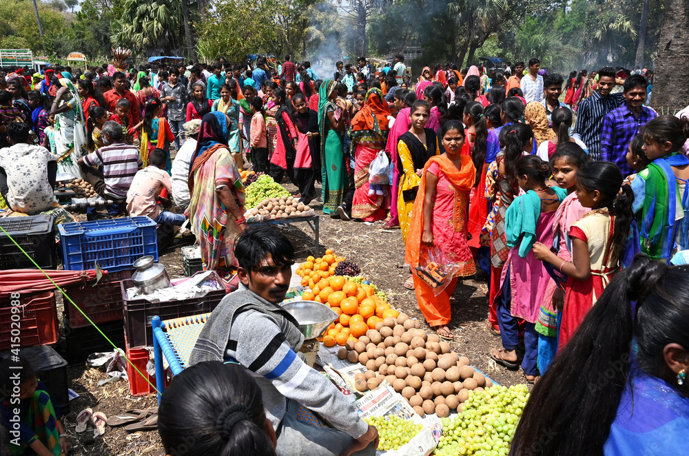 Adivasi villagers at traditional rural village fair celebrating Holi festival, Gujarat, India
