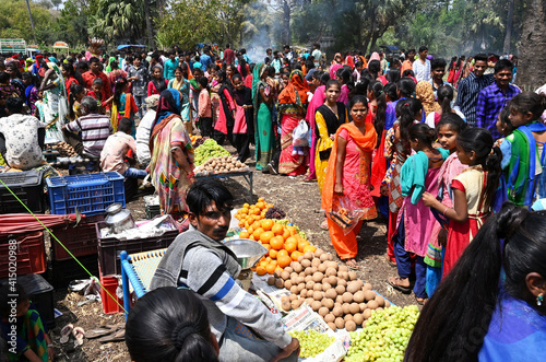 Adivasi villagers at traditional rural village fair celebrating Holi festival, Gujarat, India photo