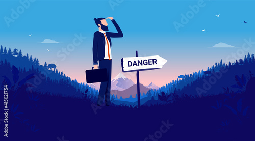 Business danger ahead - Businessman standing in front of sign pointing towards risk. Adversity and uncertainty concept. Vector illustration.