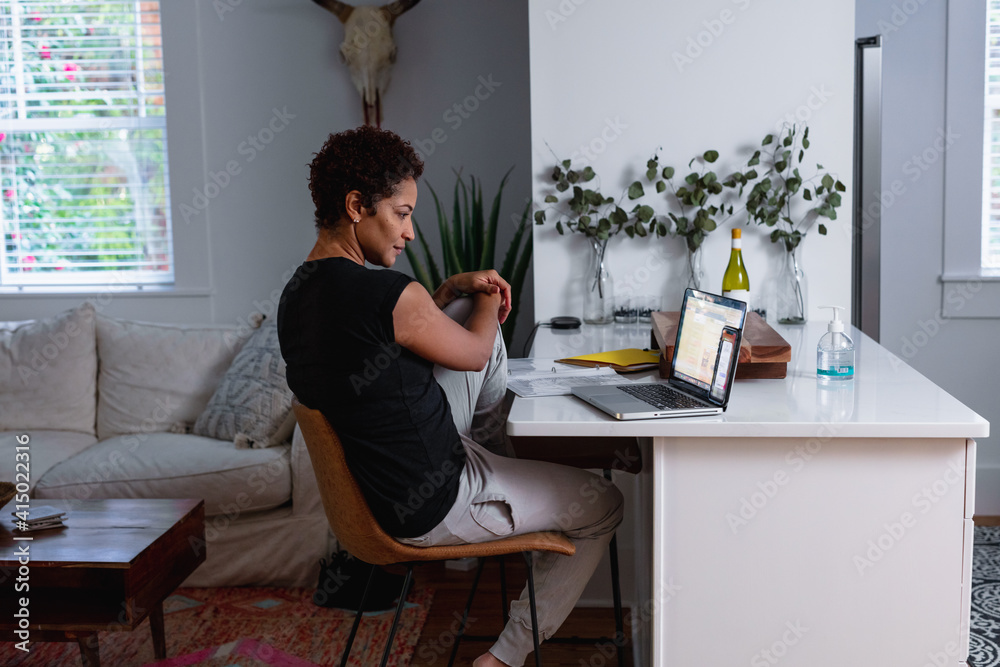 Creative woman works from home remotely using laptop