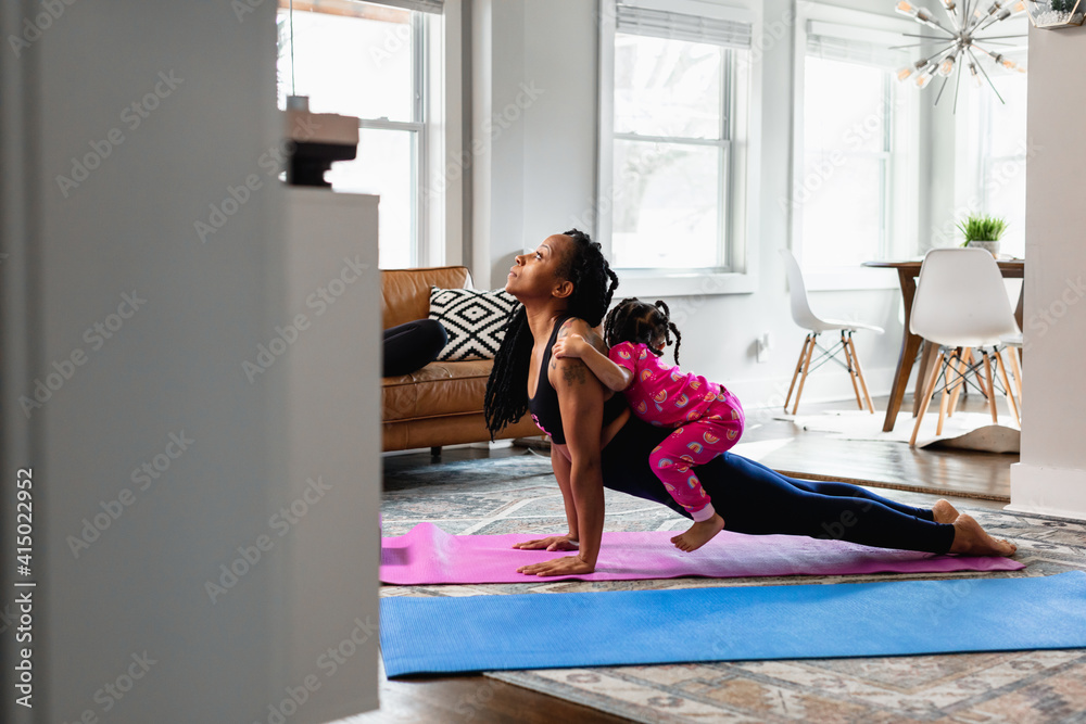 Mother and daughter working out at home doing exercises Mother and daughter working out at home doing exercises