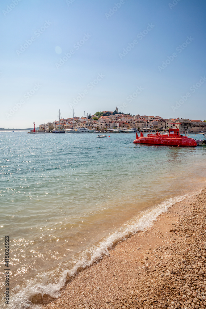 Red submarine at beach against Primosten townscape in Sibenik-Knin, Croatia Red submarine at beach against Primosten townscape in Sibenik-Knin, Croatia
