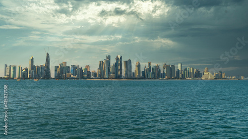 Doha Qatar skyline cityscape with skyscrapers under dramatic clouds