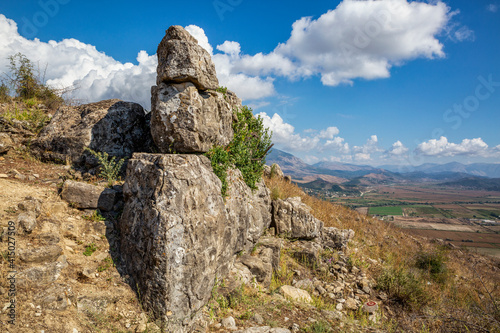 Eroded hillside boulder in summer