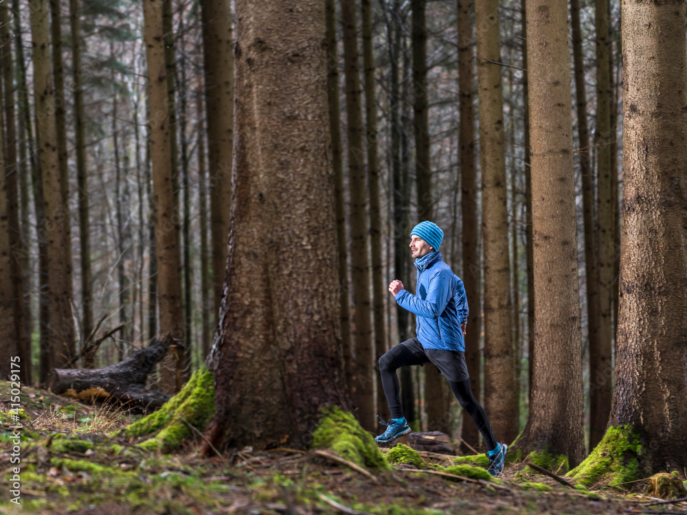 Man running in woodland during winter Man running in woodland during winter
