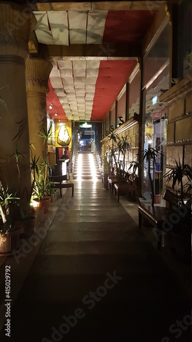 Illuminated corridor and stairs with palm trees to a shopping center in Hurghada, Egypt