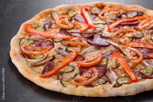 Fresh delicious pizza made in a hearth oven with sausage, pepper and tomatoes