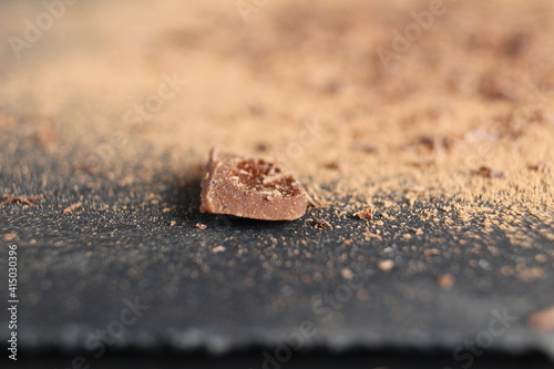 Background food crumb chocolate on a gray stone close-up background of Chocolate Day