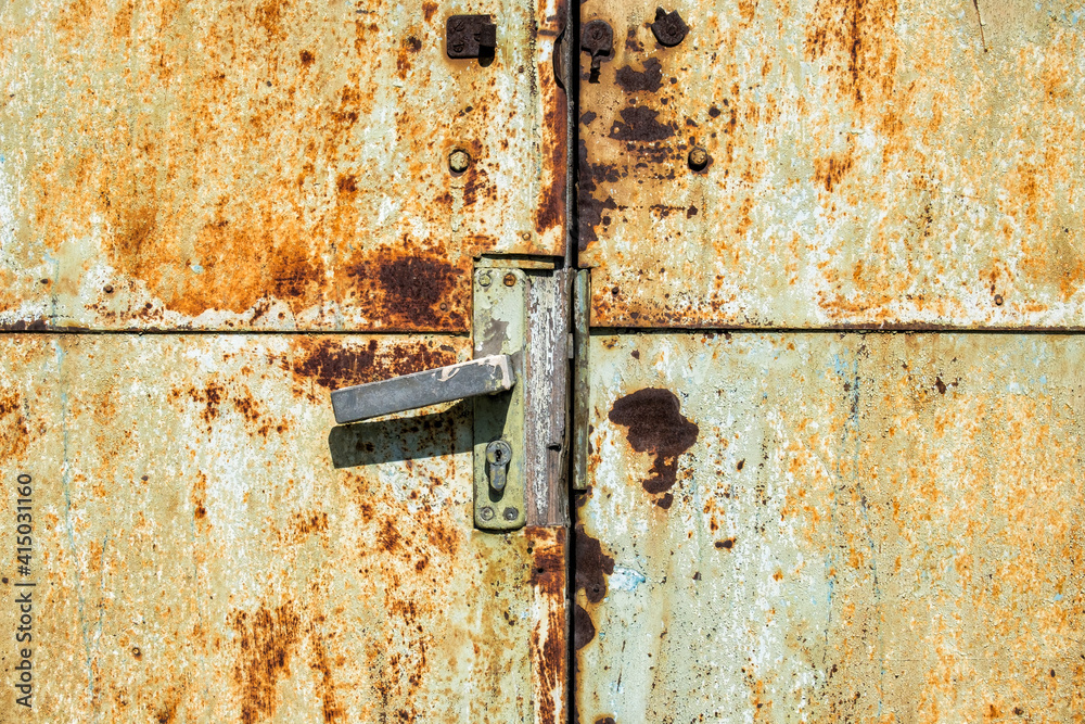 Doorknob on an old rusty metal door Doorknob on an old rusty metal door