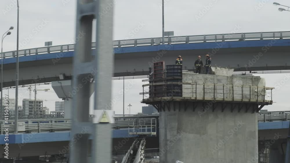 Urban industrial view from train window. Bridge constructions with road with cars Urban industrial view from train window. Bridge constructions with road with cars