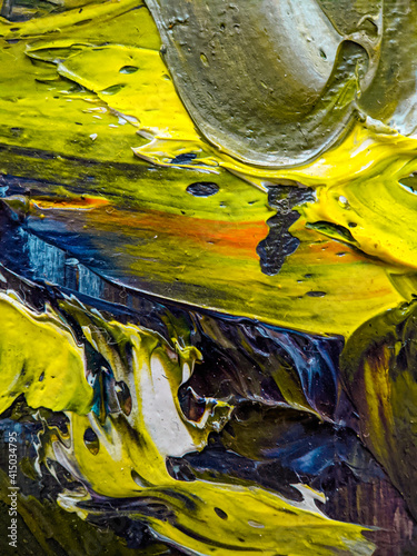 Close-up photo of the oil paints mixed in beautiful patterns on the palette