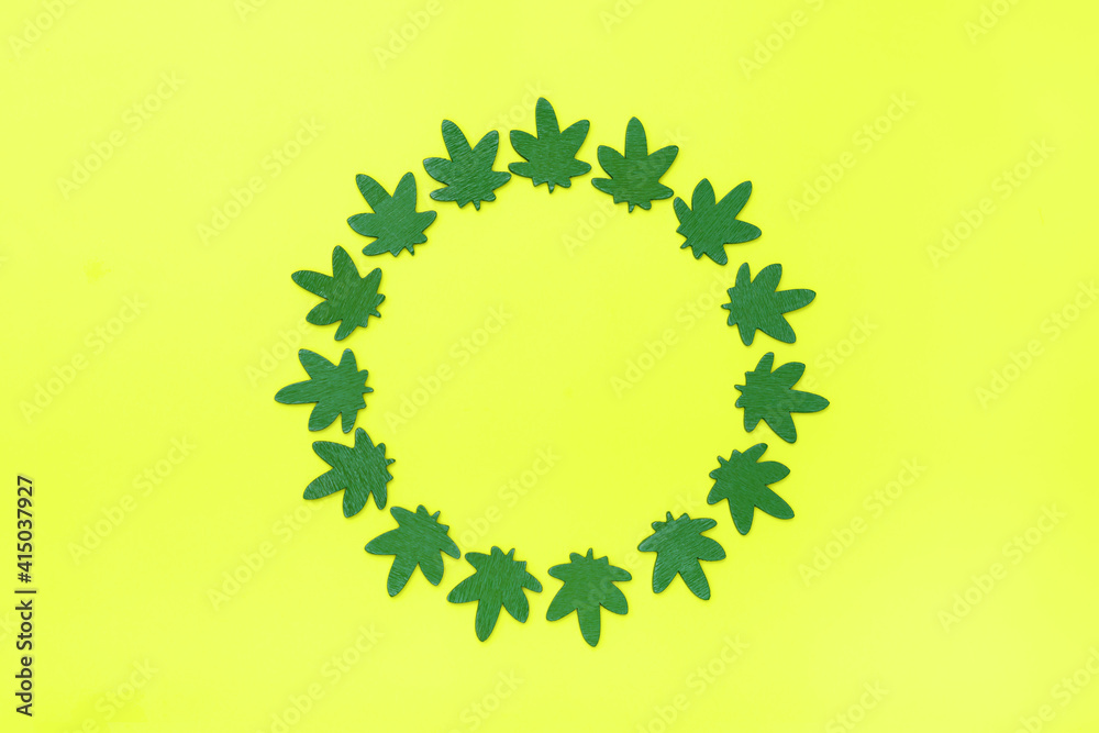 Marijuana leaves circle on gray background. Circle made from green cannabis leaves. Cannabis circle on yellow background. Marijuana leaves circle on gray background. Circle made from green cannabis leaves. Cannabis circle on yellow background.