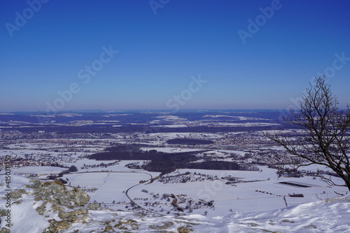 View from the top of Breitenstein on the Swabian Alb  with trees  far view  snow  wintertime  Ochsenwang near castle Teck  Bissingen unter Teck  Germany