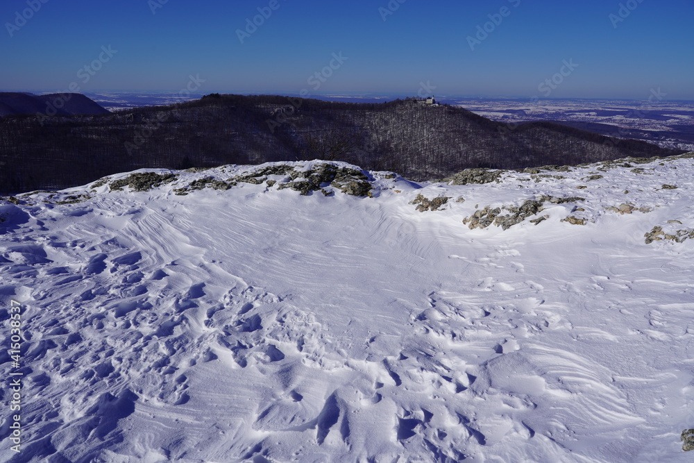 View from the top of Breitenstein on the Swabian Alb, with trees, far view, snow, wintertime, Ochsenwang near castle Teck, Bissingen unter Teck, Germany View from the top of Breitenstein on the Swabian Alb, with trees, far view, snow, wintertime, Ochsenwang near castle Teck, Bissingen unter Teck, Germany