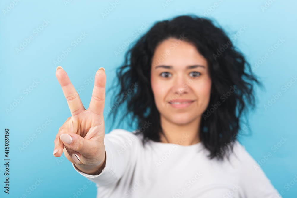 Young brunette woman covers her eyes with her hand Young brunette woman covers her eyes with her hand