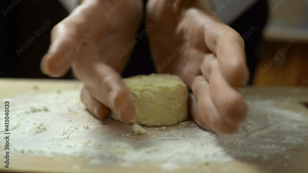 A woman prepares dessert in the kitchen. He makes cheesecakes out of a mixture of cottage cheese. The video shows the process of cooking at home. A woman prepares dessert in the kitchen. He makes cheesecakes out of a mixture of cottage cheese. The video shows the process of cooking at home.