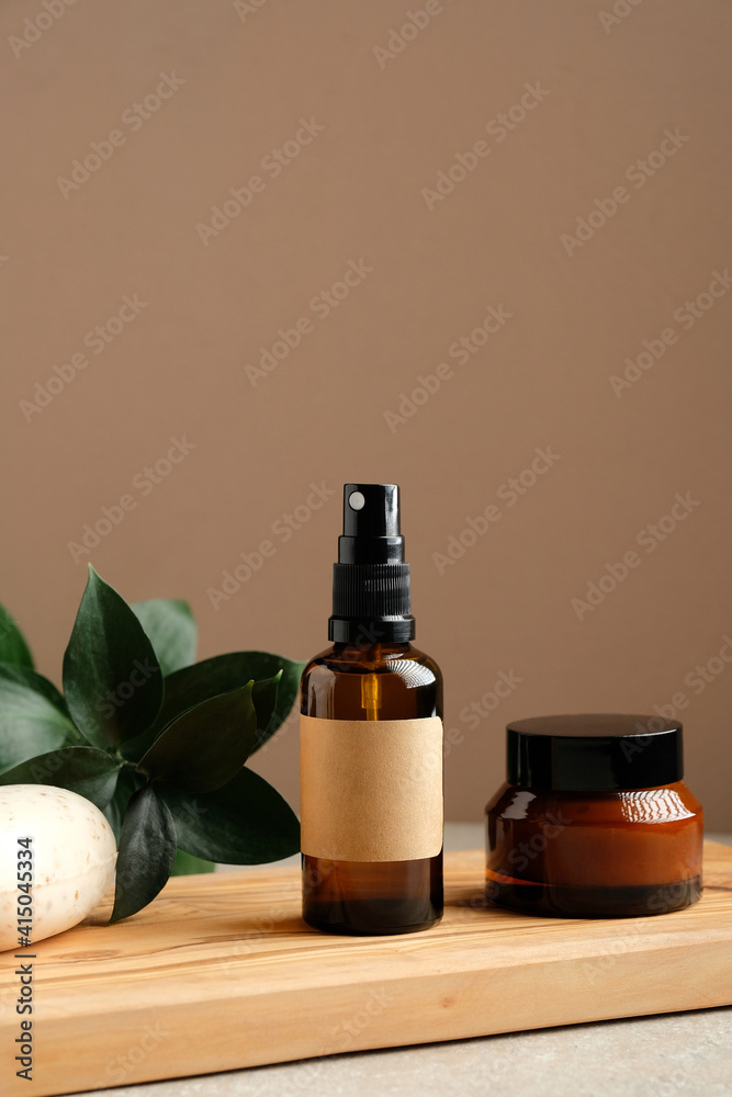 Natural organic SPA cosmetic products set with green leaves. Herbal skincare beauty products on wooden board. Spray body lotion bottle, homemade soap, jar of moisturizer cream. Bio cosmetic branding. - obrazy, fototapety, plakaty 