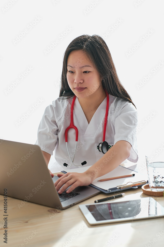 Stock photo of asian female doctor working from home. Stock photo of asian female doctor working from home.