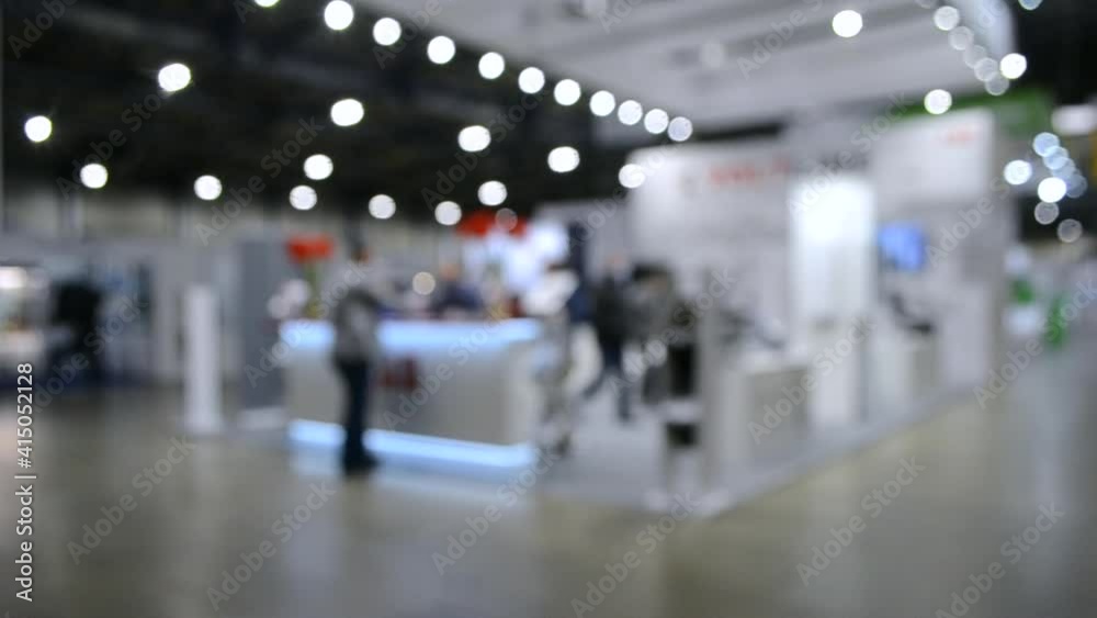 Abstract Defocused Blurred Background flow of many people inside space