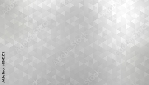 Small grey triangles mosaic pattern form silver smooth metallic surface. Empty textured background.